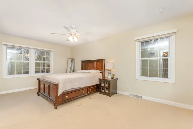 a spacious bedroom with a bed and a window