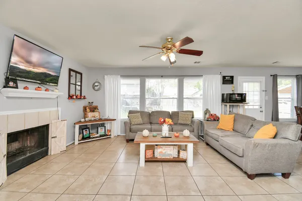 a living room with furniture a fireplace and a flat screen tv