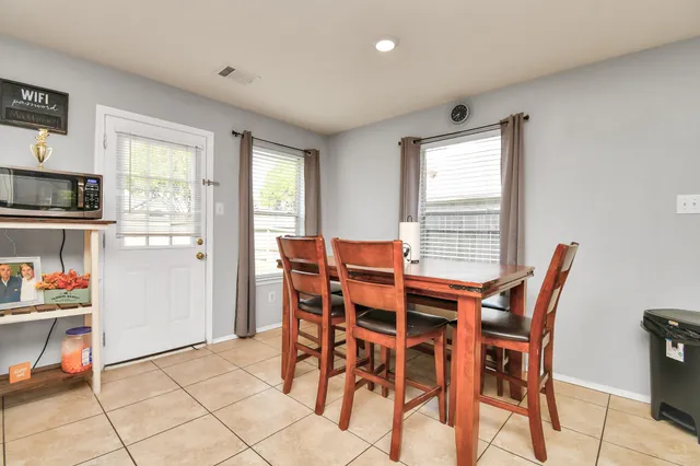 a view of a dining room with furniture and a window