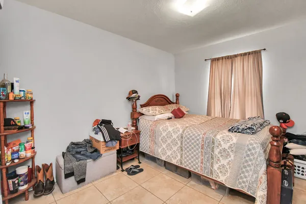 a bedroom with a bed and a dresser in it