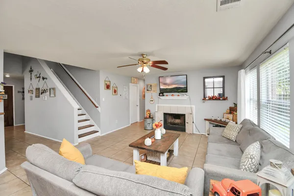 a living room with furniture fireplace and a large window