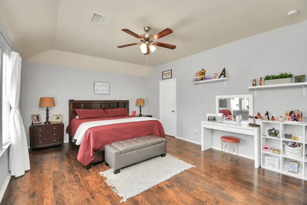 a bedroom with a bed and a chandelier