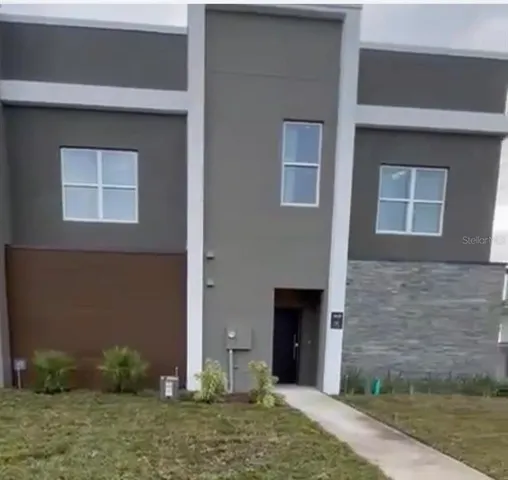 a view of a brick house with potted plants