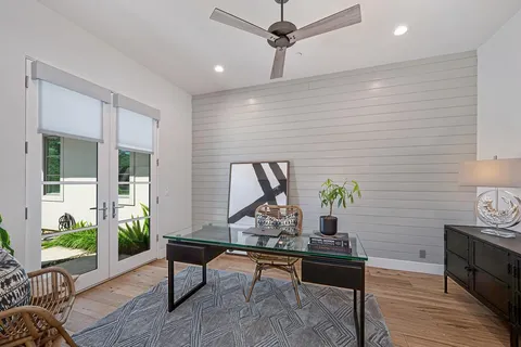 a dining room with furniture a chandelier and wooden floor