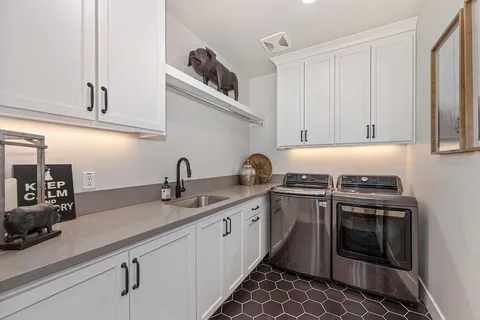 a bathroom with double vanity sink toilet and shower