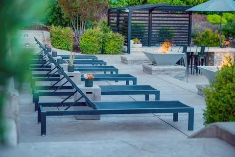 a view of a patio with couches and a table and chairs with garden view