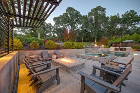 a view of a house with pool and sitting area