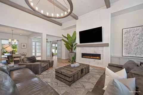 a living room with fireplace furniture and a wooden floor