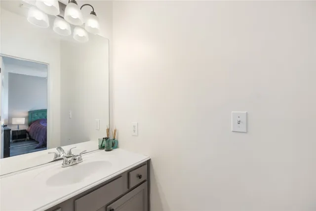 a bathroom with a sink vanity and mirror