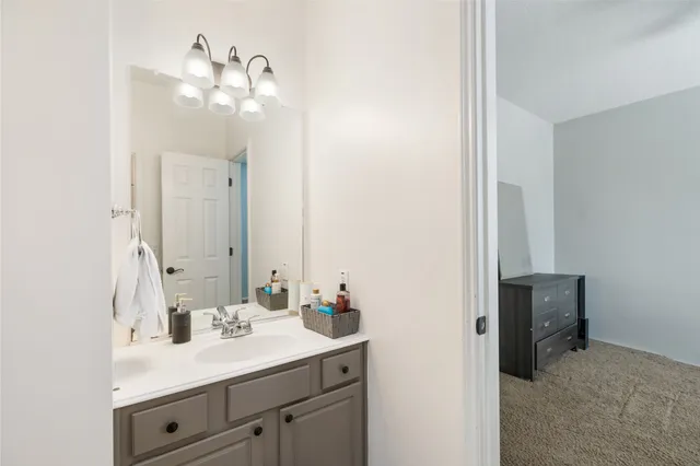 a en suite bathroom with a sink and a mirror