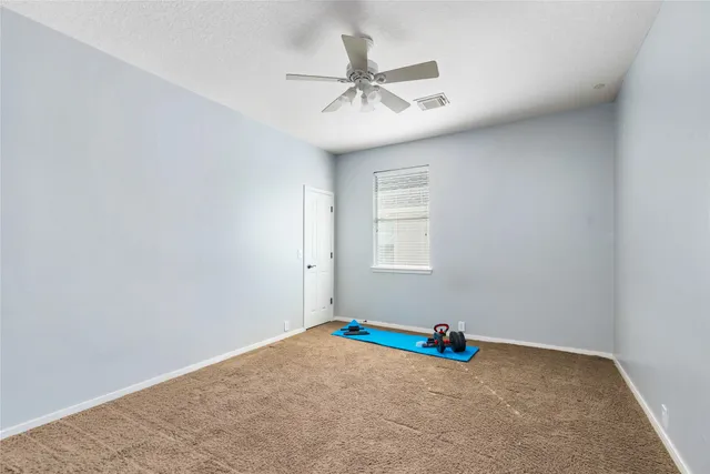 a room with a ceiling fan and a window
