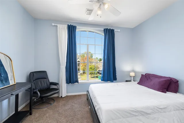 a bedroom with a large bed and a window