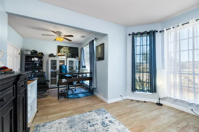 a view of a livingroom with workspace and a window