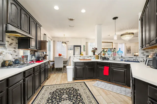 a kitchen with stainless steel appliances granite countertop a sink stove and cabinets