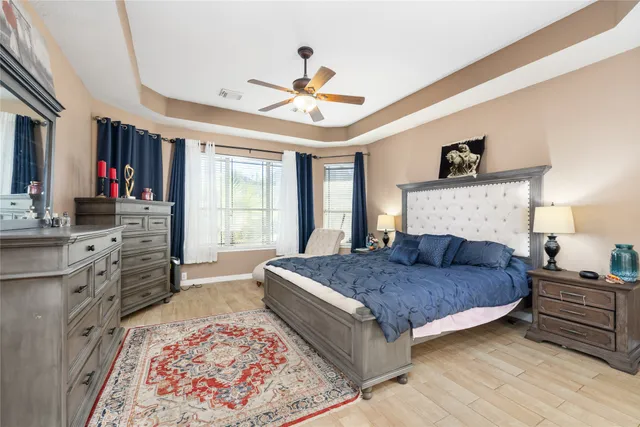 a bedroom with a large bed and a window