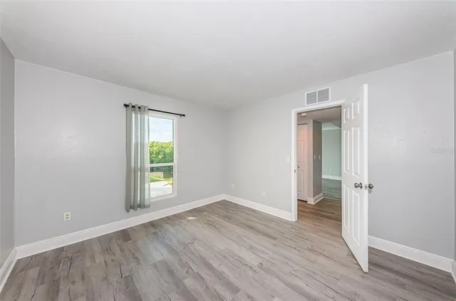 a bedroom with a bed and a potted plant