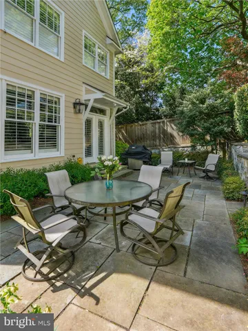 a view of a patio with table and chairs and potted plants