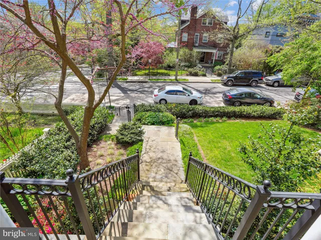 a view of a pathway with a wrought fence