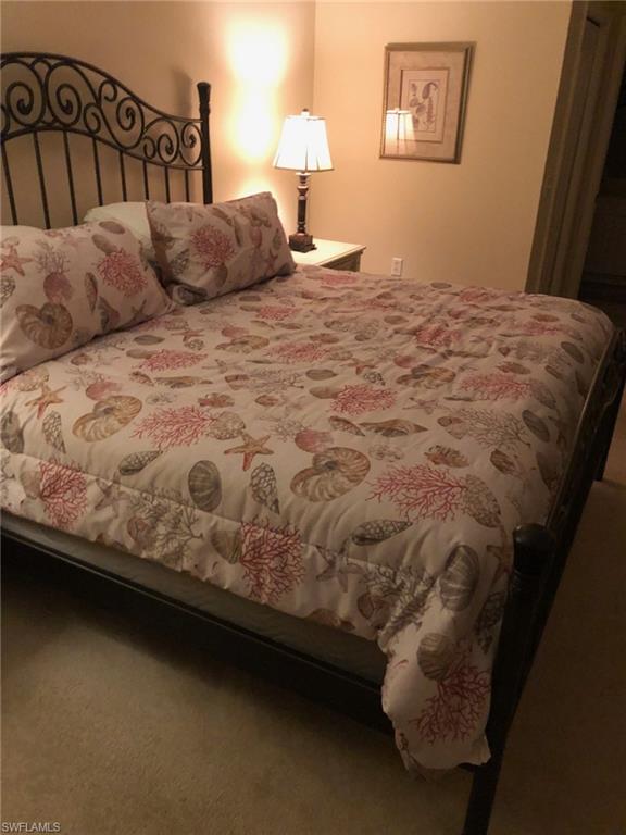 1911 Morning Sun Lane Naples, FL 34119 - Photo 11 of 17 a bed sitting in a bedroom next to a window