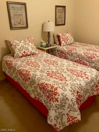 a large bed sitting in a bedroom next to a wall