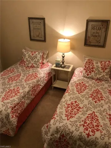 a bedroom with a bed and painting on the wall