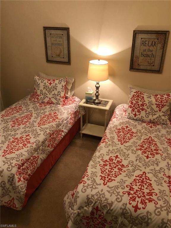 1911 Morning Sun Lane Naples, FL 34119 - Photo 14 of 17 a bedroom with a bed and painting on the wall