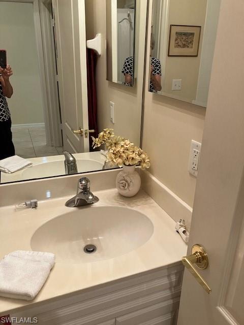 1911 Morning Sun Lane Naples, FL 34119 - Photo 16 of 17 a bathroom with a sink and a mirror