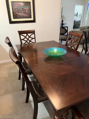 wooden floor with table and chairs