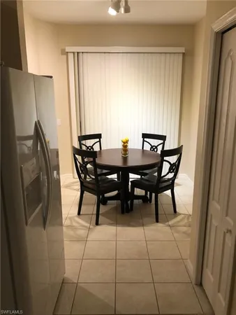 a view of a dining room with furniture and window