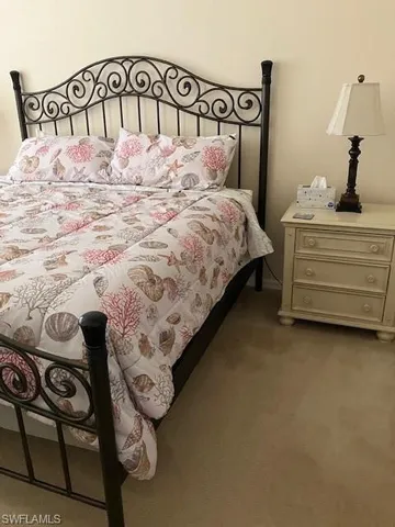 a bedroom with a bed and a table in it