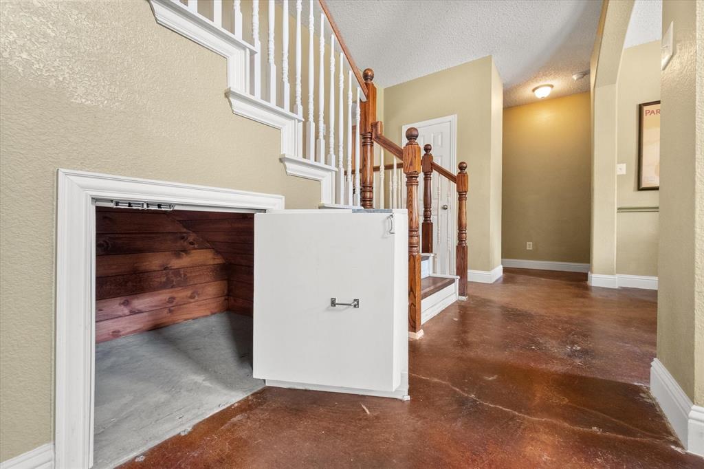 1305 Liverpool Lane Mansfield, TX 76063 - Photo 3 of 40 The property features a staircase with white risers and wood treads, a wood handrail, and white balusters