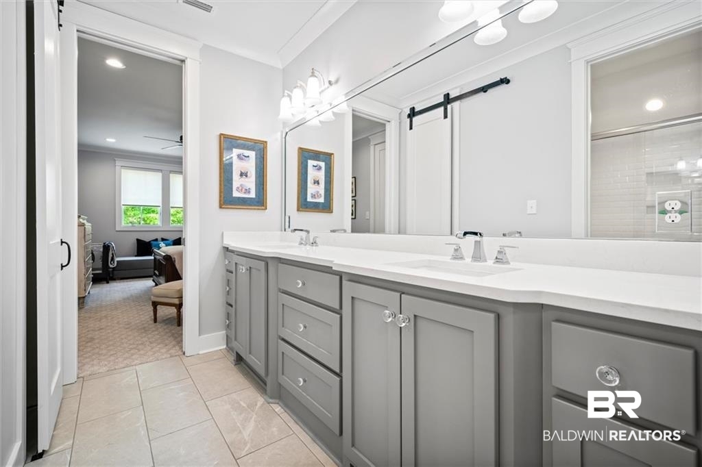 707 Cardamel Court Fairhope, AL 36532 - Photo 30 of 40 Bathroom with tile patterned floors, double sink vanity, and crown molding
