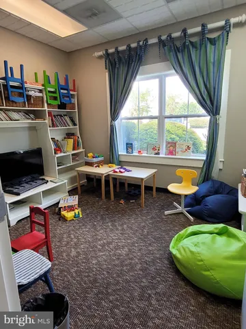 a room with gym equipment and a flat screen tv
