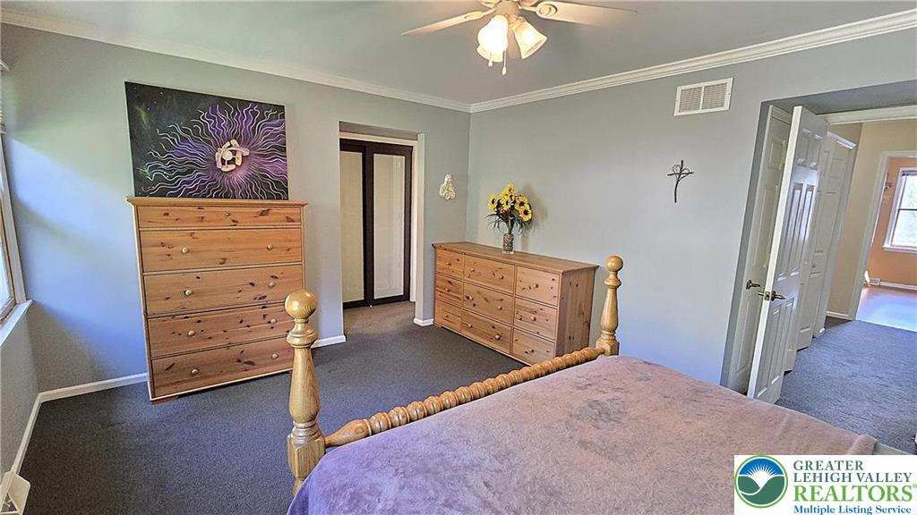 194 Springhouse Road Allentown, PA 18104 - Photo 18 of 34 This cozy bedroom features plush carpeting, crown molding, and ample natural light.