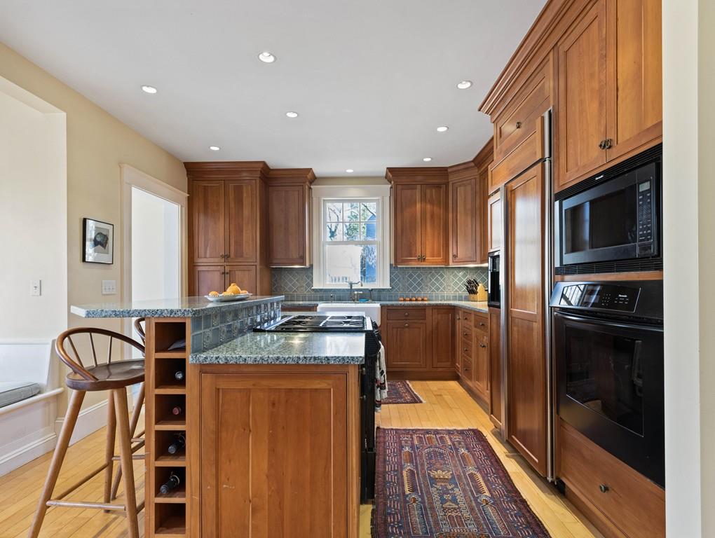 22 Cushing Road Wellesley, MA 02481 - Photo 15 of 28 a kitchen with stainless steel appliances granite countertop a refrigerator a stove top oven a sink and dishwasher