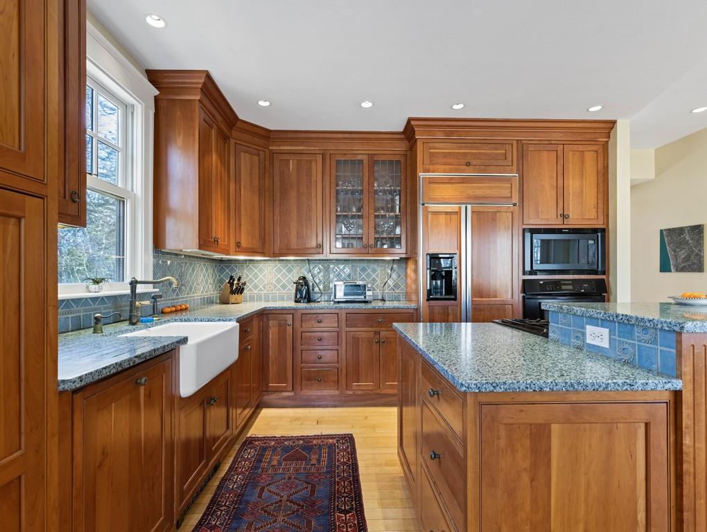 22 Cushing Road Wellesley, MA 02481 - Photo 16 of 28 a kitchen with stainless steel appliances granite countertop a sink stove and refrigerator