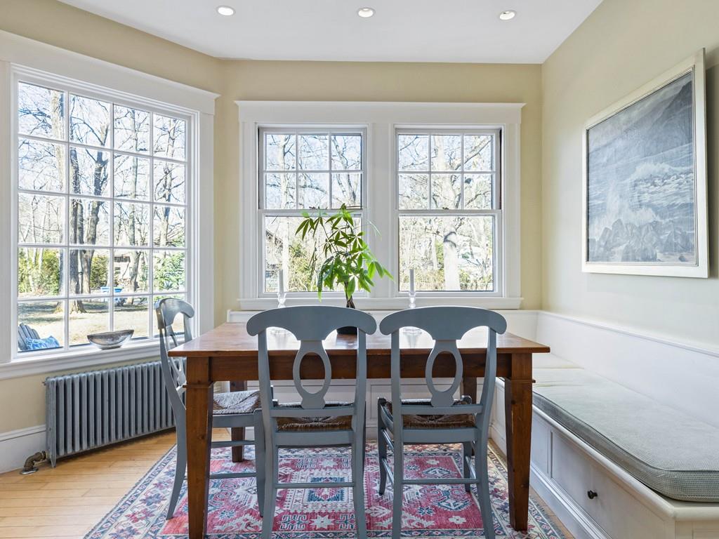 22 Cushing Road Wellesley, MA 02481 - Photo 18 of 28 a view of a dining room with furniture a couch and wooden floor