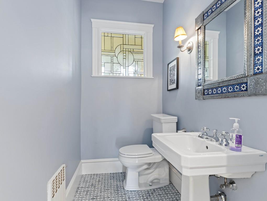 22 Cushing Road Wellesley, MA 02481 - Photo 21 of 28 a bathroom with a sink a toilet and a mirror