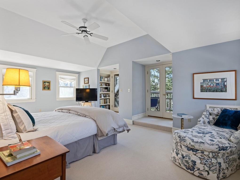 22 Cushing Road Wellesley, MA 02481 - Photo 26 of 28 a spacious bedroom with a large bed and a chandelier