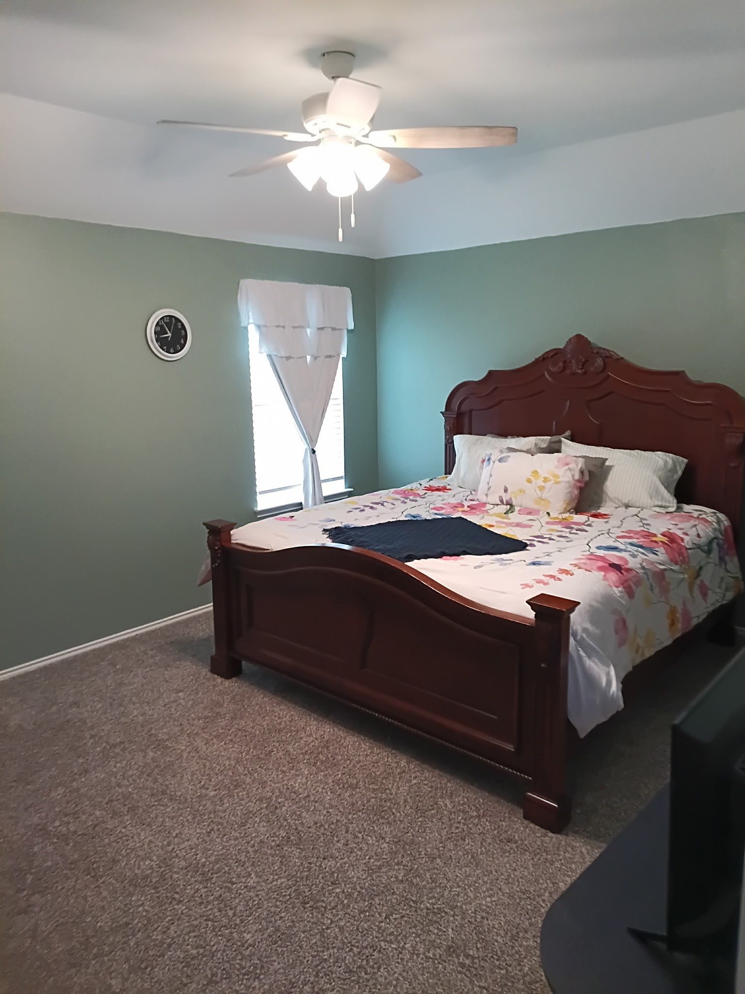 14968 Bergamot Colony Street Splendora, TX 77372 - Photo 17 of 25 a bedroom with a bed and a chandelier