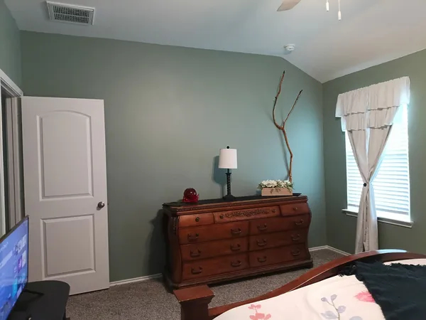 a room with a bed and a mirror