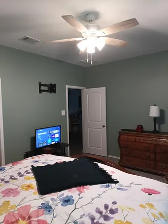 a bedroom with a bed and a chandelier