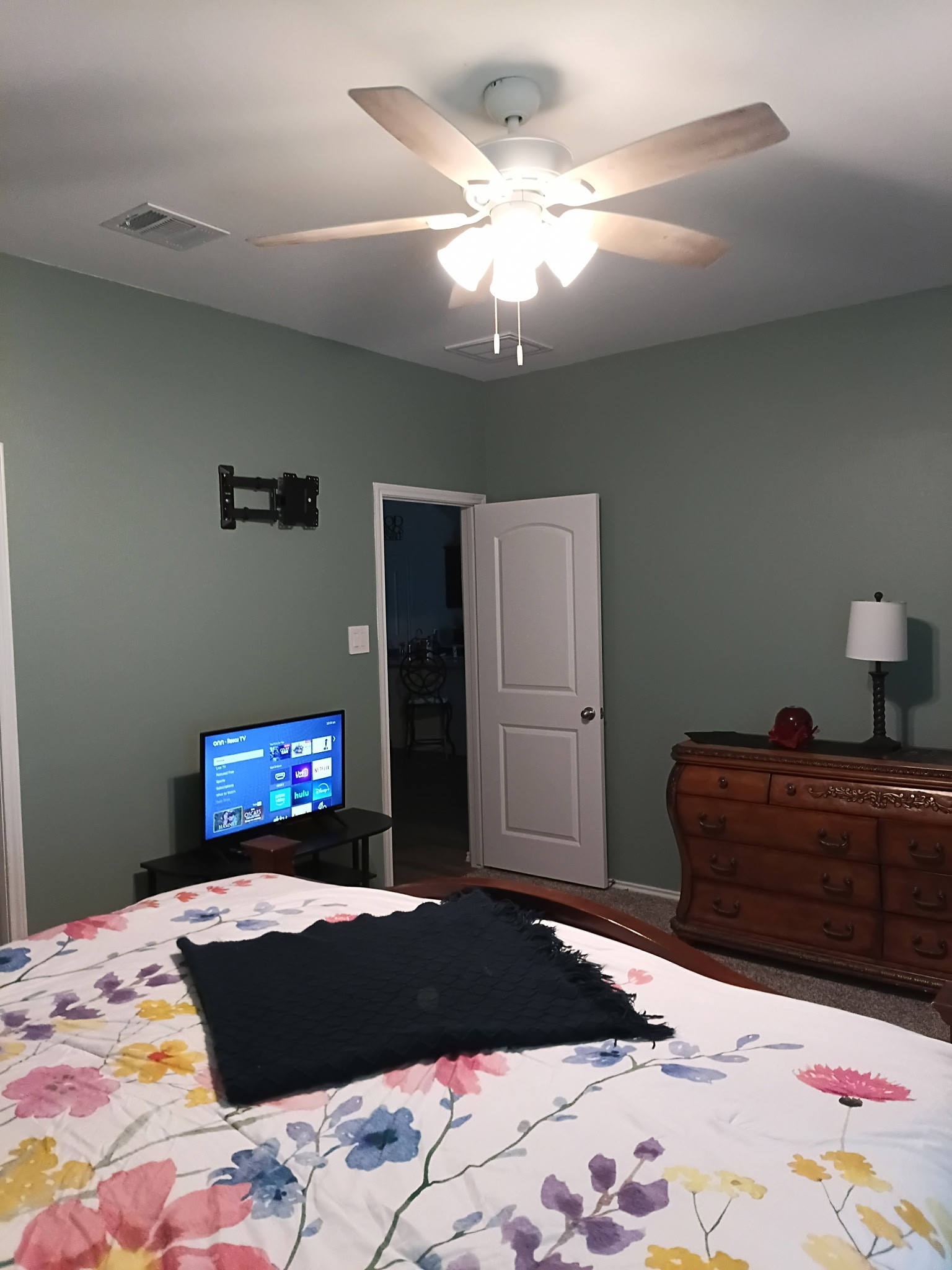 14968 Bergamot Colony Street Splendora, TX 77372 - Photo 19 of 25 a bedroom with a bed and a chandelier