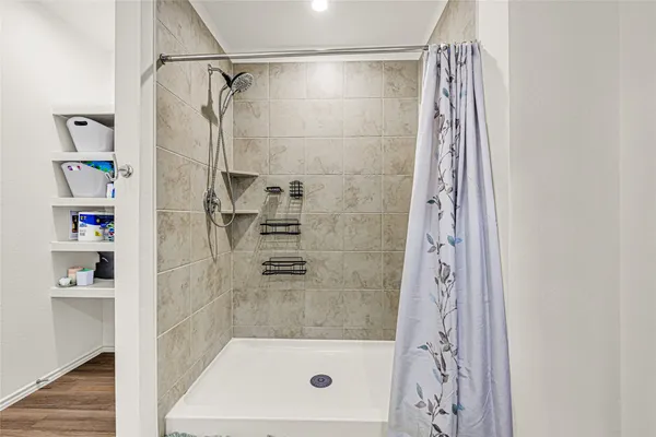 a bathroom with a shower curtain and a sink