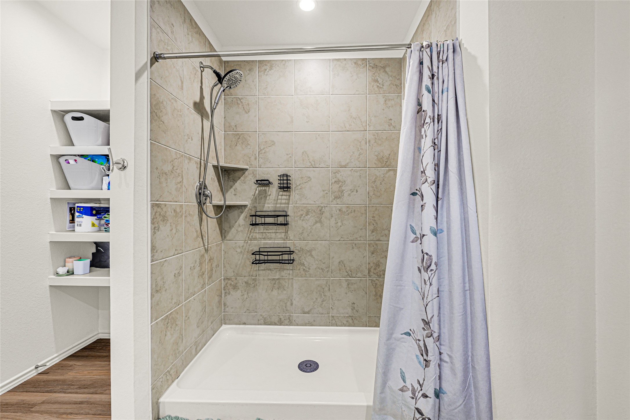 14968 Bergamot Colony Street Splendora, TX 77372 - Photo 20 of 25 a bathroom with a shower curtain and a sink
