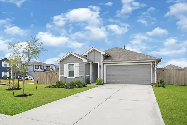 a front view of a house with a garden and yard