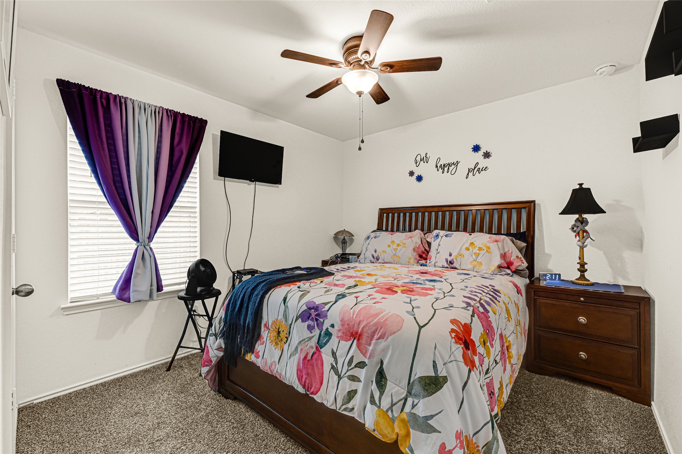 14968 Bergamot Colony Street Splendora, TX 77372 - Photo 22 of 25 a bed sitting in a bedroom next to a window