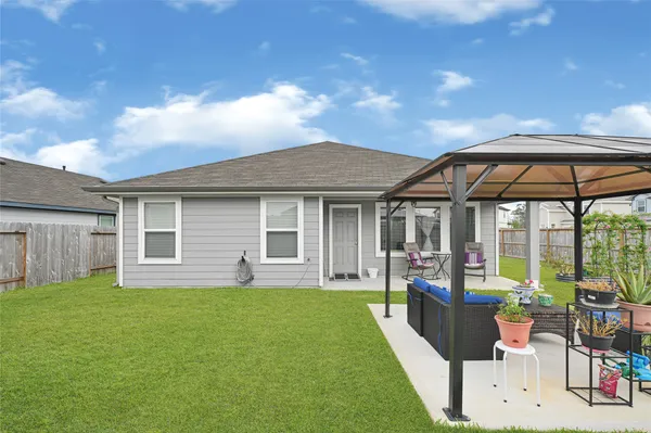 a front view of house with yard outdoor seating and barbeque oven