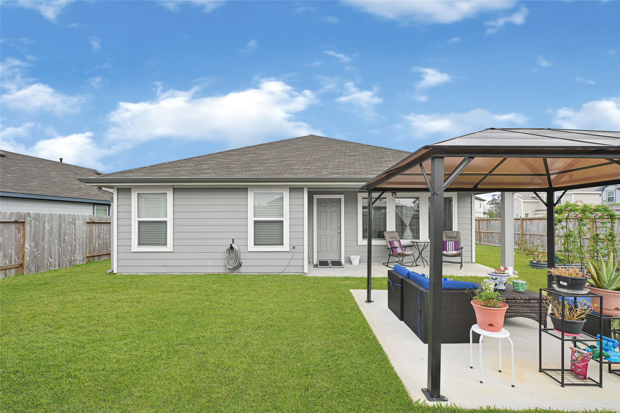 14968 Bergamot Colony Street Splendora, TX 77372 - Photo 3 of 25 a front view of house with yard outdoor seating and barbeque oven