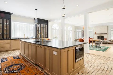 a kitchen with granite countertop a stove and a sink